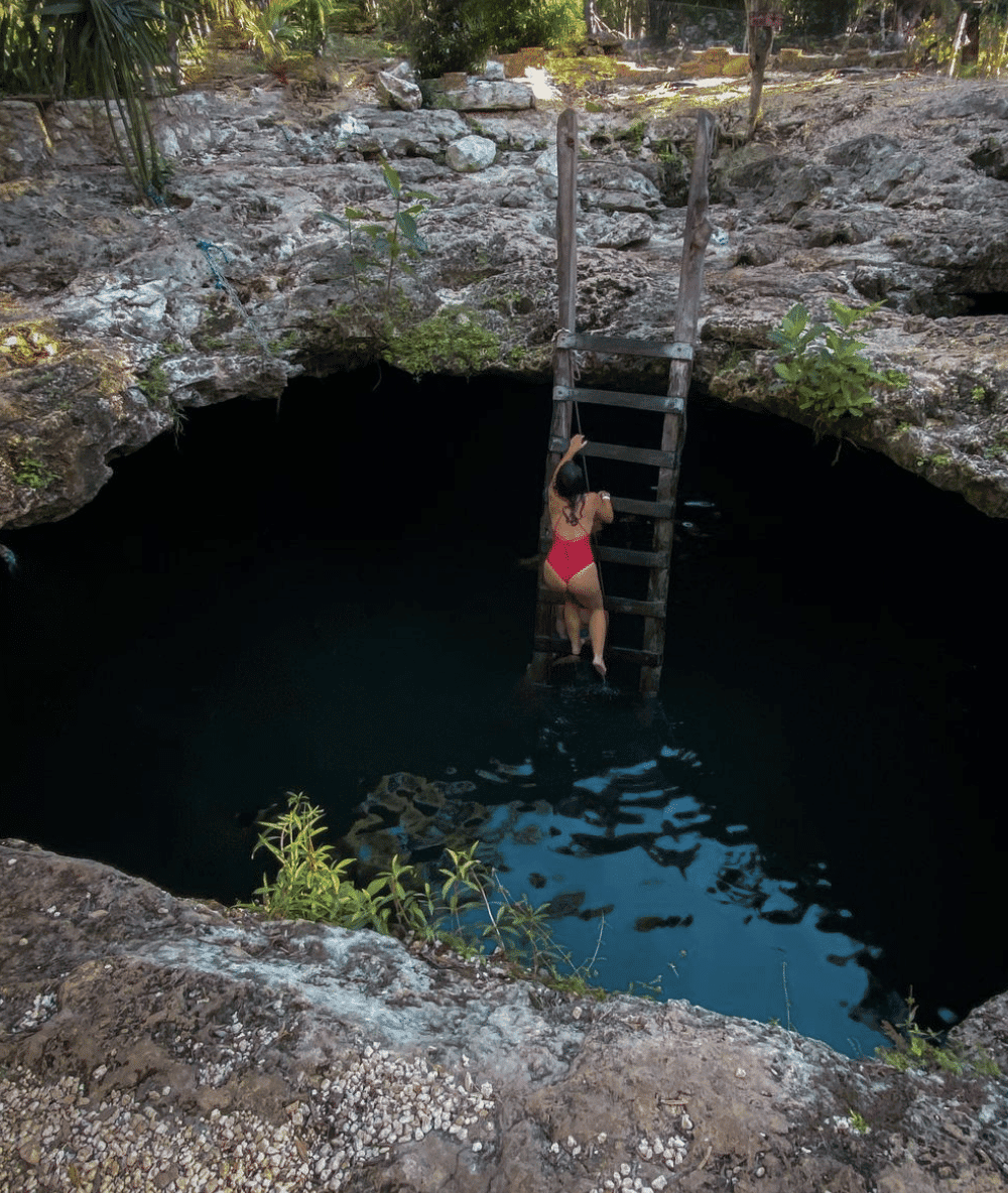 Climbing up the ladder at the cenote