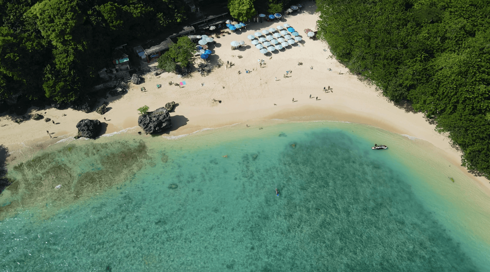 sky view of Padang Padang beach in Bali, with surfers in the water
