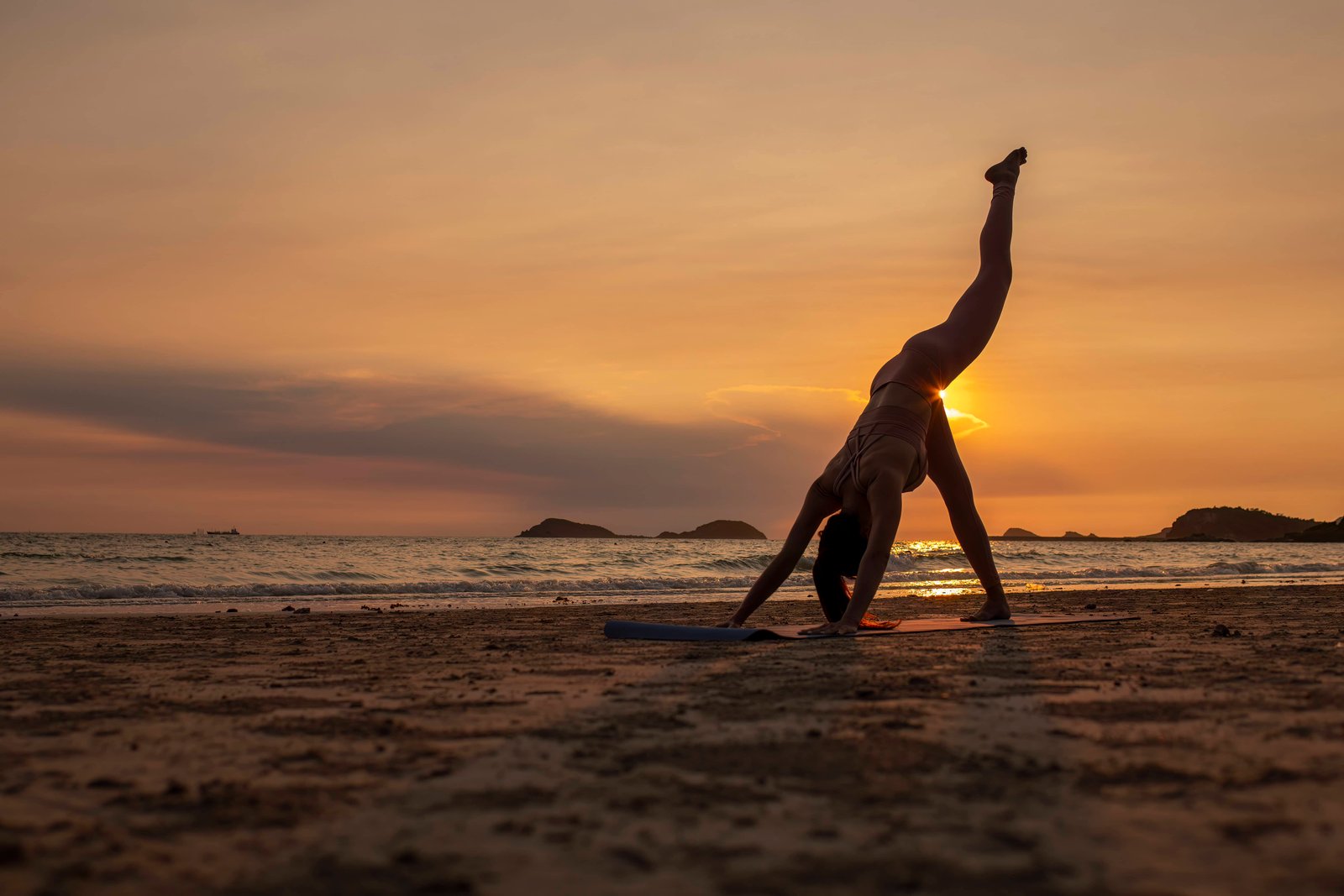 Yoga at the beach during sunset