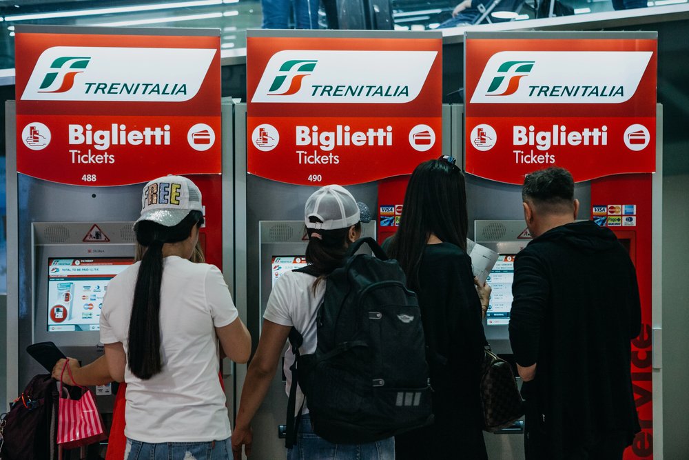 People buy tickets at self-service machines
