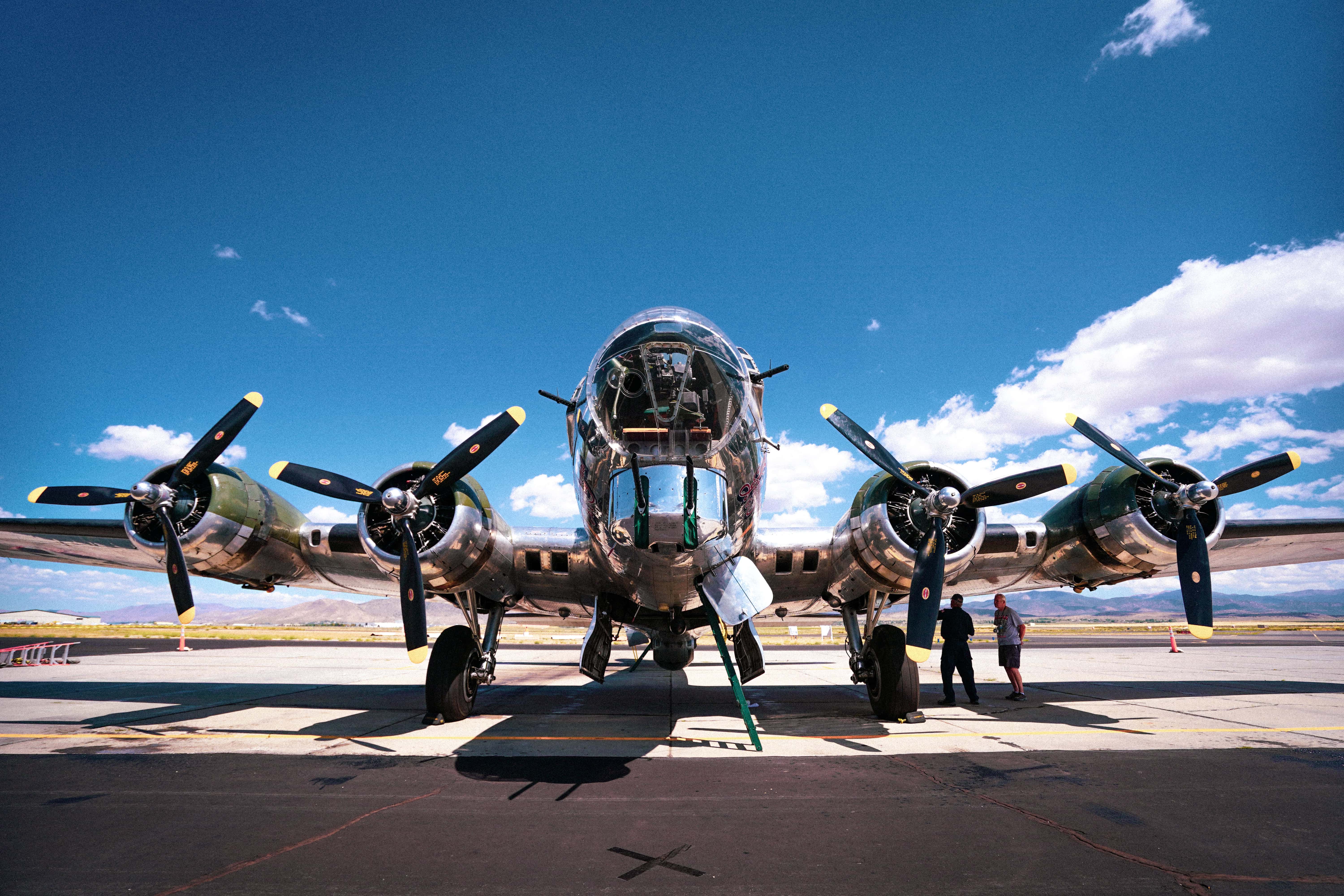 A low angle shot of a B-17 bomber plane from WWII captured on an airbase on a sunny day